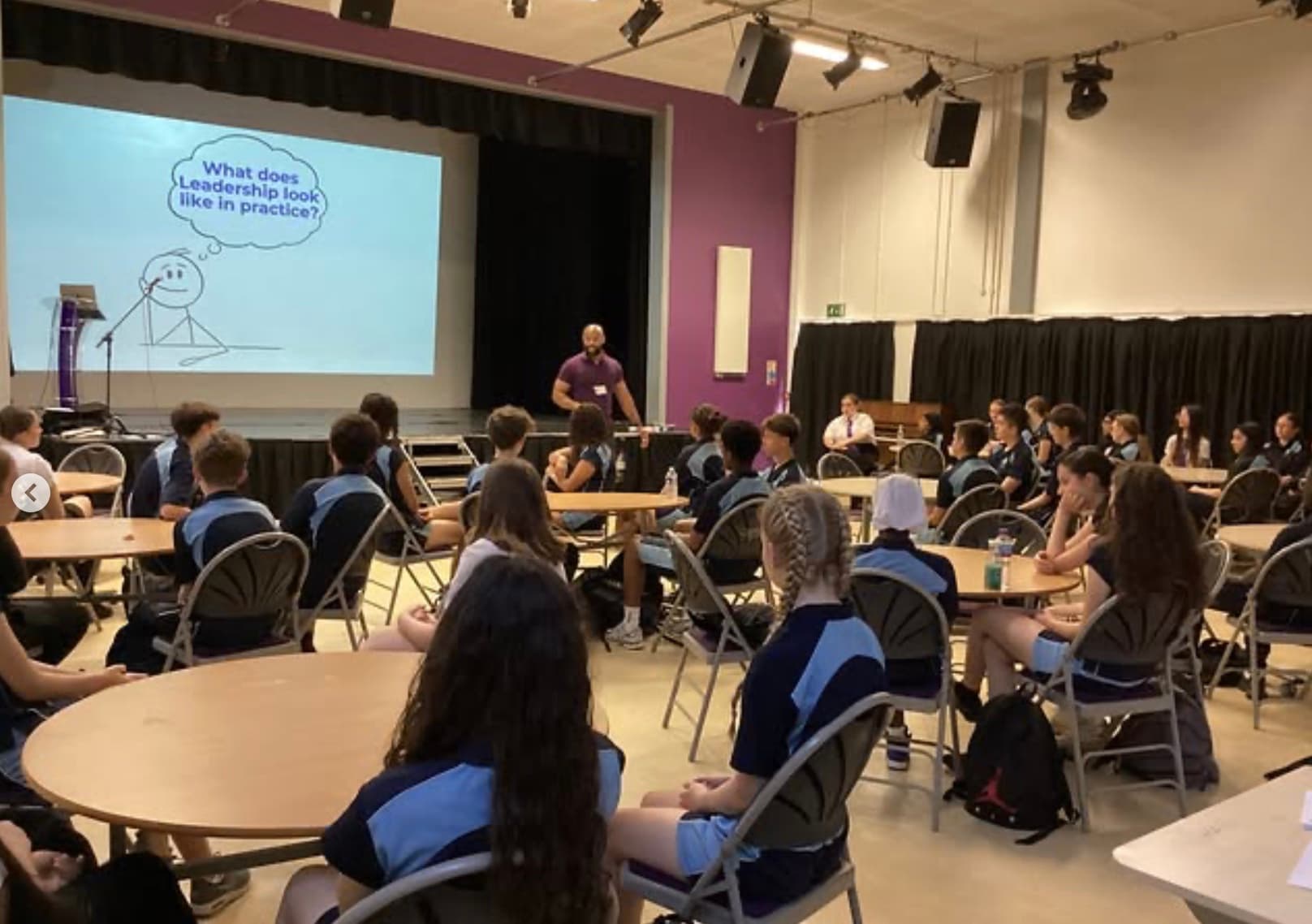 Frank leading a workshop with students at round tables